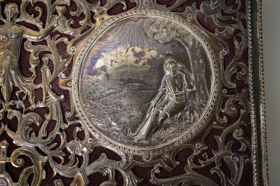 A white metal mounted rectangular desk folder, with beaded borders and pierced and decorated with scrolling foliage, birds and oval panels depicting figures at various pursuits, stamped '13', 30.6cm. Condition - poor to